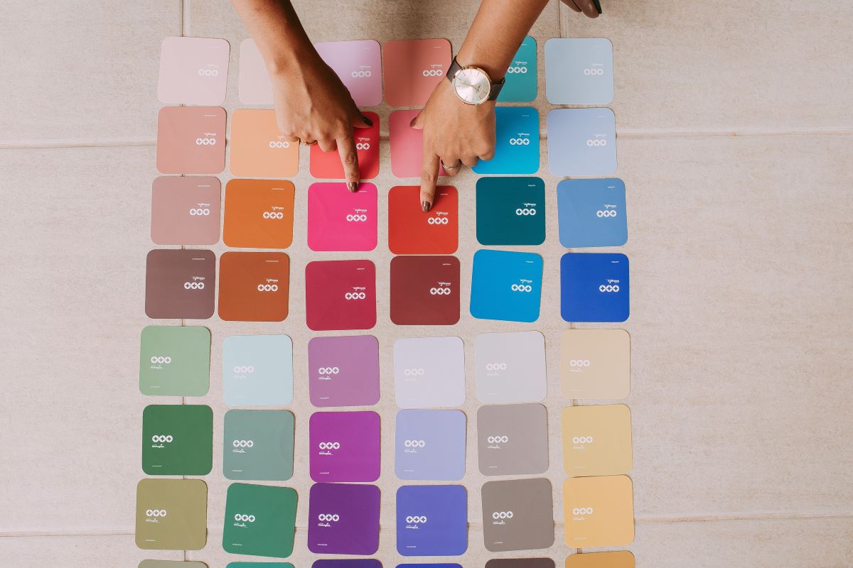 hands pointing at color palette cards